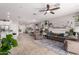 Spacious living room featuring tile floors, neutral walls, and a ceiling fan at 9341 W Willow Bend Ln, Phoenix, AZ 85037