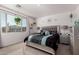 The main bedroom boasts plenty of natural light, plush carpet, and silver accents on the furniture and decor at 9341 W Willow Bend Ln, Phoenix, AZ 85037