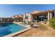 Backyard pool with patio seating, lounge chairs, and lush landscaping, creating a serene outdoor retreat at 9341 W Willow Bend Ln, Phoenix, AZ 85037