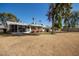 Large backyard showcasing mature trees and the home's rear exterior at 10105 W Bolivar Dr, Sun City, AZ 85351