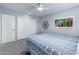 Carpeted bedroom with a geometric patterned bedspread and closet at 10105 W Bolivar Dr, Sun City, AZ 85351