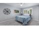 Bedroom with a blue patterned bedspread, ceiling fan, and shuttered window at 10105 W Bolivar Dr, Sun City, AZ 85351