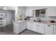 Bright kitchen featuring white cabinetry, stainless steel sink, and wood-look tile floors at 10105 W Bolivar Dr, Sun City, AZ 85351