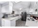 Bright kitchen featuring white cabinetry, tile flooring, and modern appliances at 10105 W Bolivar Dr, Sun City, AZ 85351