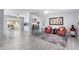 Bright living room features wood-look tile flooring, neutral wall colors, and ample seating at 10105 W Bolivar Dr, Sun City, AZ 85351