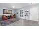 Cozy living room with wood-look tile flooring, ceiling fan, and neutral color palette at 10105 W Bolivar Dr, Sun City, AZ 85351