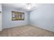 Comfortable bedroom with light blue walls, carpeted floor, and a ceiling fan at 10218 W Forrester Dr, Sun City, AZ 85351