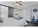 Comfortable main bedroom featuring wood look floors, sliding barn door to bathroom, and white furniture at 10242 E Sable Ave, Mesa, AZ 85212