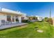 Backyard with green grass and white patio at 10411 N 106Th Ave, Sun City, AZ 85351