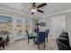 Bright dining area features a glass table, blue chairs, tile floors, and access to the backyard at 10411 N 106Th Ave, Sun City, AZ 85351