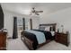 Relaxing main bedroom with ceiling fan, dark wood furniture and access to a private balcony at 10411 N 106Th Ave, Sun City, AZ 85351