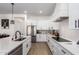 Spacious kitchen featuring white cabinetry, stainless steel appliances, and quartz countertops at 10464 Magnolia Rd, Gold Canyon, AZ 85118