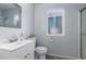 This bathroom features a single vanity with a framed mirror and a window for natural light at 10808 W Kelso Dr, Sun City, AZ 85351