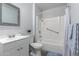 A full bathroom boasts shower and bathtub, along with a single vanity and framed mirror at 10808 W Kelso Dr, Sun City, AZ 85351