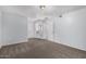 A carpeted bedroom has neutral colors and lots of natural light with a view into the hall and bathroom at 10808 W Kelso Dr, Sun City, AZ 85351