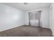 This bedroom has carpeted floors and a window with curtains for natural light at 10808 W Kelso Dr, Sun City, AZ 85351