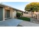 Inviting front entrance with low maintenance synthetic grass, brick wall and lush tree at 10808 W Kelso Dr, Sun City, AZ 85351