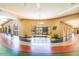 Bright, spacious hallway with colorful flooring, large windows, and inviting seating area at 10808 W Kelso Dr, Sun City, AZ 85351