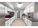 Practical kitchen featuring tiled floors, white cabinetry and mosaic backsplash at 10808 W Kelso Dr, Sun City, AZ 85351
