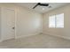 Bedroom with neutral colored walls, fan and wood-look tile floors at 11416 S 208Th Ave, Buckeye, AZ 85326