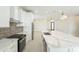 Well-lit kitchen with marble countertops, backsplash and an open floor plan at 11416 S 208Th Ave, Buckeye, AZ 85326