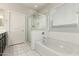 Bright bathroom featuring a soaking tub, glass enclosed shower and white marble floors at 1149 E Sourwood Dr, Gilbert, AZ 85298