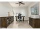 Well-lit office with ceiling fan, wood-look tile, a desk, and wood furniture at 1149 E Sourwood Dr, Gilbert, AZ 85298