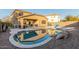 View of the backyard pool surrounded by rock features and a basketball hoop at 1149 E Sourwood Dr, Gilbert, AZ 85298