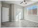Bright bedroom with a ceiling fan, closet, and natural light streaming through the window at 11537 W Laurelwood Ln, Avondale, AZ 85392