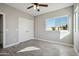 Comfortable bedroom with a ceiling fan, closet, and window view of the outdoors at 11537 W Laurelwood Ln, Avondale, AZ 85392