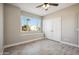 Well-lit bedroom with a window view and a ceiling fan at 11537 W Laurelwood Ln, Avondale, AZ 85392