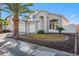 Charming home with a large front yard, mature palm trees, and a three car garage at 11537 W Laurelwood Ln, Avondale, AZ 85392