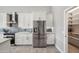 Bright kitchen with stainless steel refrigerator, tiled backsplash, and a view into a large pantry at 11537 W Laurelwood Ln, Avondale, AZ 85392
