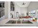 Open-concept kitchen and living area with modern finishes and a large island with seating at 11537 W Laurelwood Ln, Avondale, AZ 85392