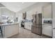 Contemporary kitchen with white cabinets, stainless steel appliances, and modern backsplash at 11537 W Laurelwood Ln, Avondale, AZ 85392