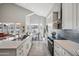 Bright kitchen featuring a large island, white cabinetry, stainless steel appliances and lots of light at 11537 W Laurelwood Ln, Avondale, AZ 85392