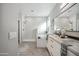 Modern primary bathroom with double vanity, walk-in shower, soaking tub, and elegant tile design at 11537 W Laurelwood Ln, Avondale, AZ 85392