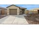 Charming single-story home featuring a two-car garage, desert landscaping, and a covered entryway at 12089 E Sunflower Ln, Florence, AZ 85132