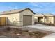 A single story home showcasing the two-car garage and desert landscaping at 12089 E Sunflower Ln, Florence, AZ 85132