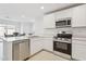 Modern kitchen featuring stainless steel appliances, quartz countertops, and white cabinetry at 12089 E Sunflower Ln, Florence, AZ 85132