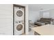 Convenient in-unit laundry with a stacked washer and dryer, next to a cozy living space at 12089 E Sunflower Ln, Florence, AZ 85132