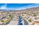 Aerial view of a desert community offering a pool, mature landscaping, and mountain views at 1349 E Rock Wren Rd, Phoenix, AZ 85048