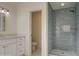 Elegant bathroom featuring a tile shower with a built-in niche and white vanity at 1349 E Rock Wren Rd, Phoenix, AZ 85048