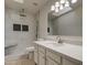 Bathroom with tiled walk-in shower, rainfall showerhead, white vanity, and large mirror at 1349 E Rock Wren Rd, Phoenix, AZ 85048
