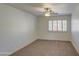 Bedroom with neutral carpet, ceiling fan, and window with shutters at 1349 E Rock Wren Rd, Phoenix, AZ 85048