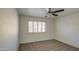 This bedroom features carpeted floors, a ceiling fan, and a window with shutters for natural light at 1349 E Rock Wren Rd, Phoenix, AZ 85048