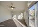 Cozy bedroom with a ceiling fan and sliding glass doors leading to a private balcony at 1349 E Rock Wren Rd, Phoenix, AZ 85048