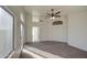 A bright and airy bedroom featuring large windows, a ceiling fan, and access to a private balcony at 1349 E Rock Wren Rd, Phoenix, AZ 85048