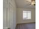 Bedroom features carpet flooring, a ceiling fan, and a window that provides natural light at 1349 E Rock Wren Rd, Phoenix, AZ 85048