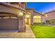 Charming home with a lush green lawn and cozy front porch, garage door entry, and fresh landscaping at 1349 E Rock Wren Rd, Phoenix, AZ 85048
